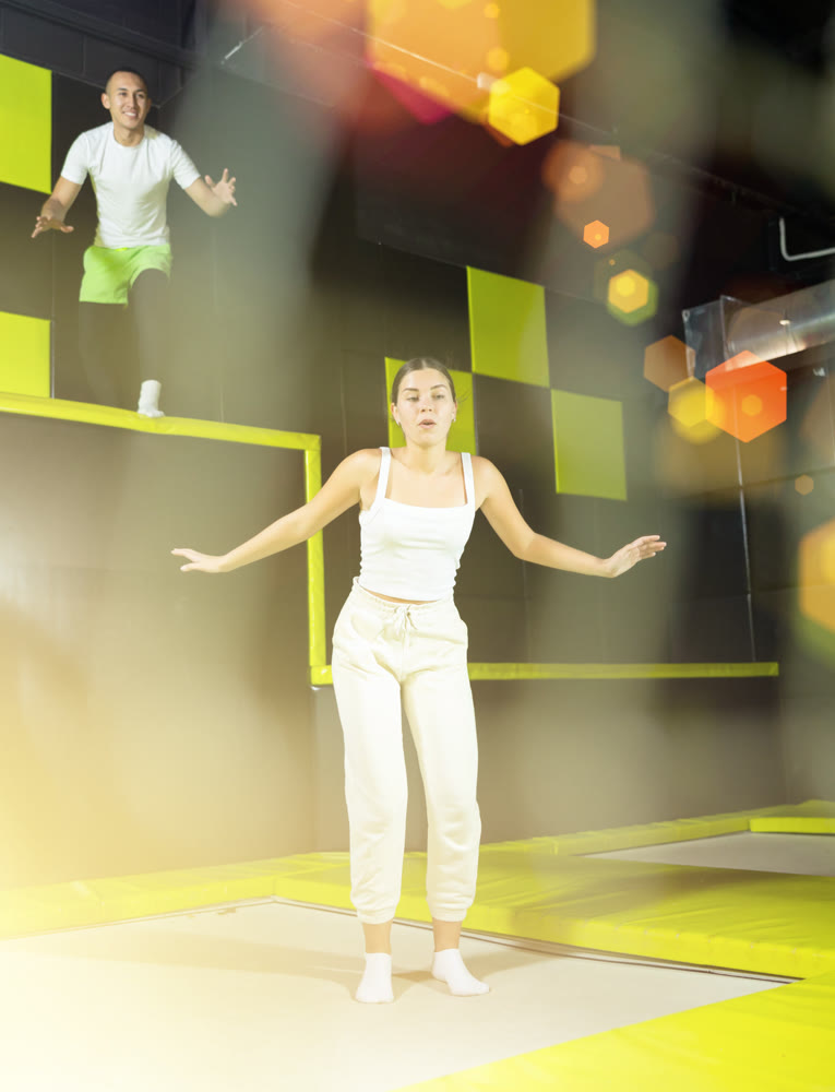 Woman sportswoman fitness jumping on club trampoline