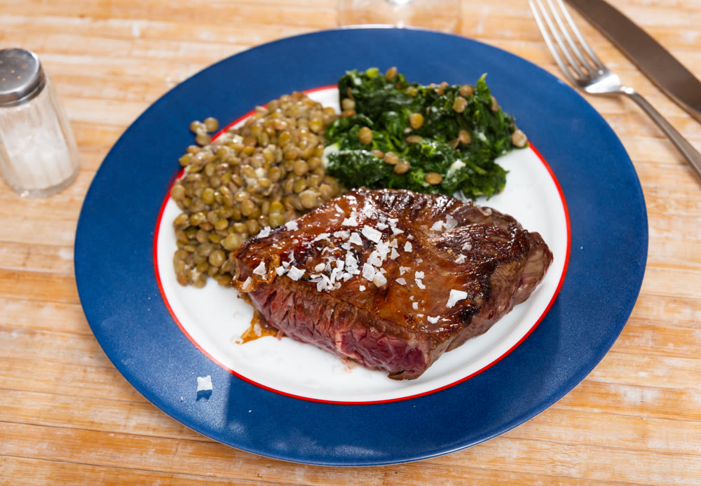 Grilled veal tenderloin with stewed lentils and spinach