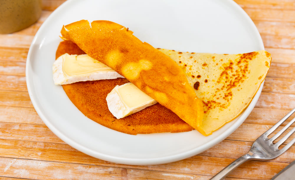 Crepes served in a plate with brie cheese