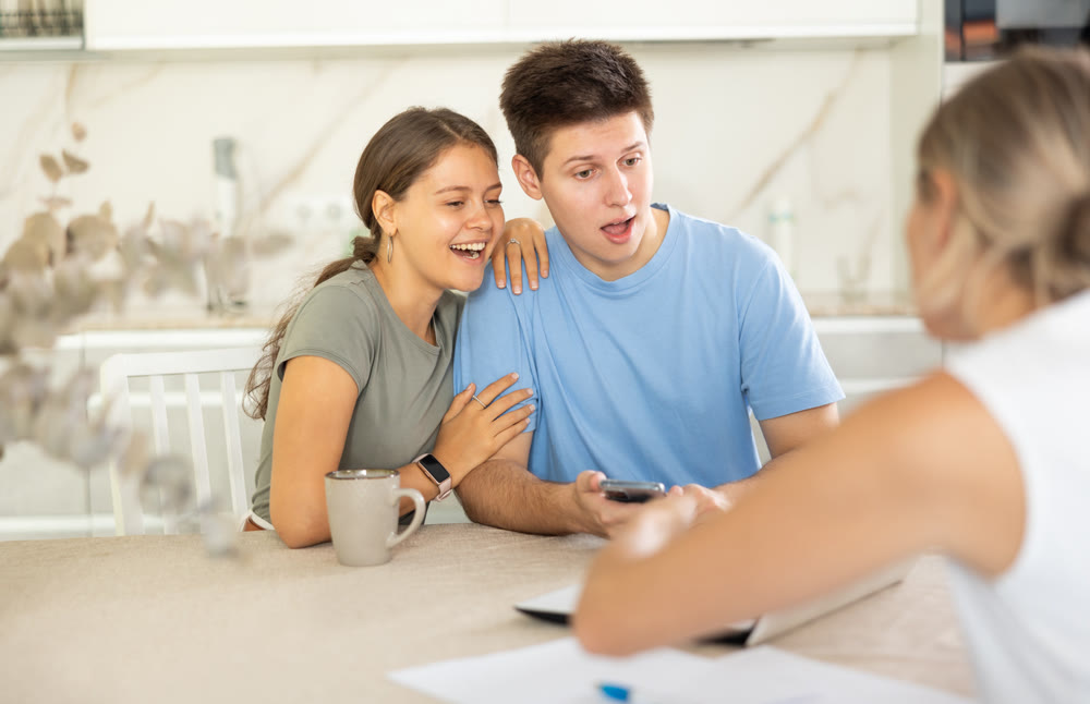 Married couple clients listen attentively and intently to woman of seller