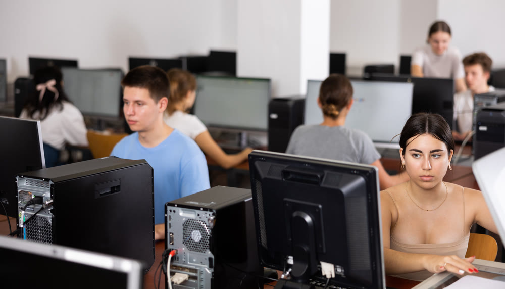 Schoolgirl uses a scanner in the computer class of school