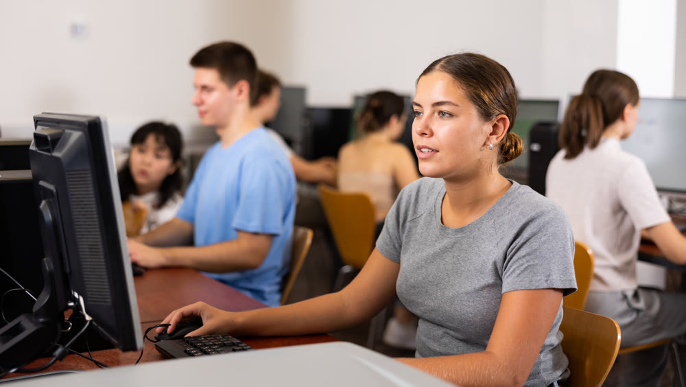Woman studying computer science in classroom