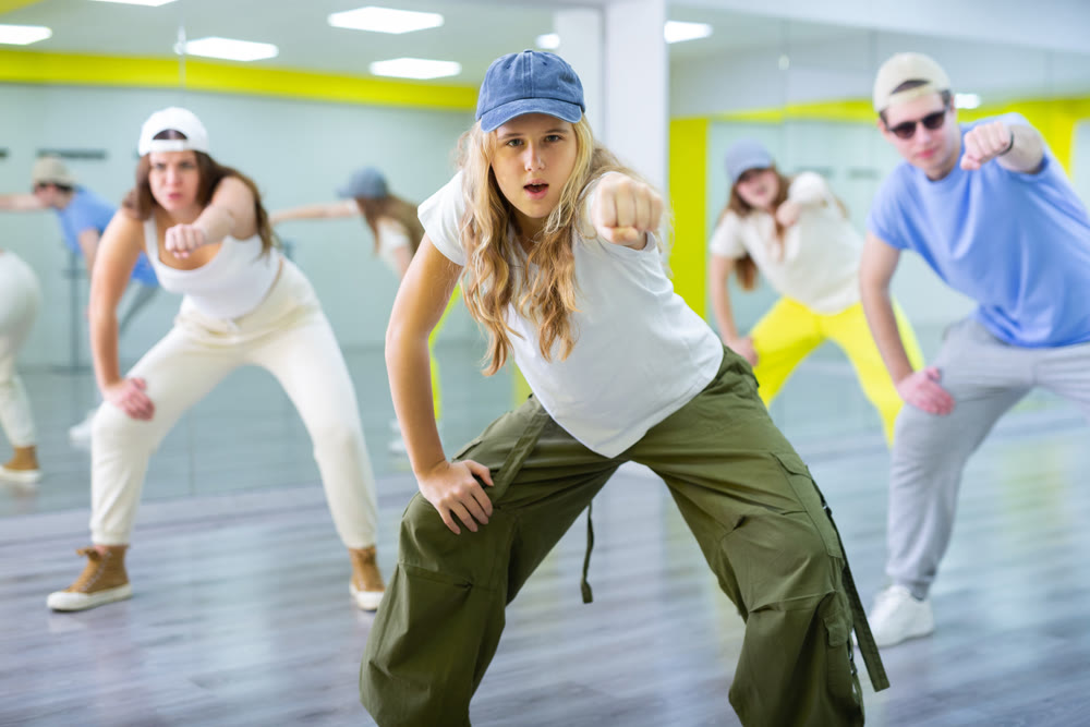 Teenages hip hop dancers doing dance workout during group class