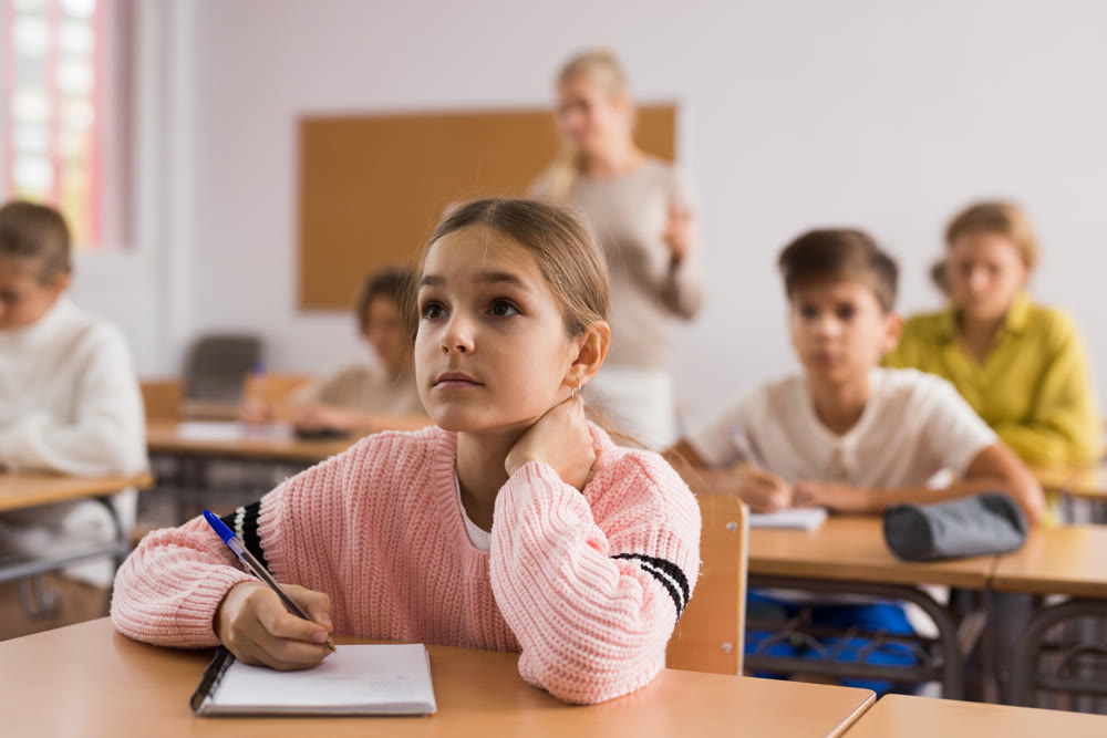 Teenage students are sitting at their desks