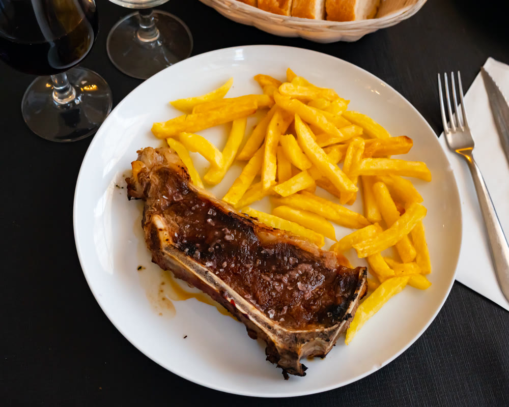 Steak served on plate with french fries