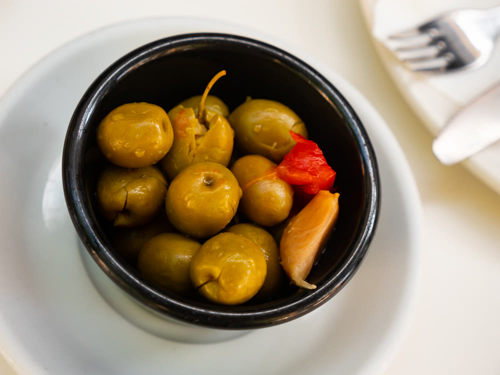 Pickled green olives with pits and garlic