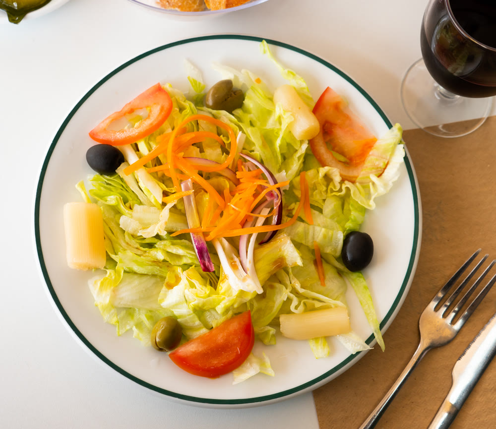 Delicious salad with carrots, olives and celery