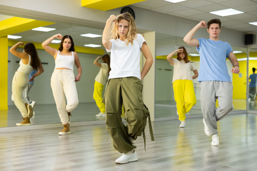 Teenage girl training breakdance Toprock moves in dance hall