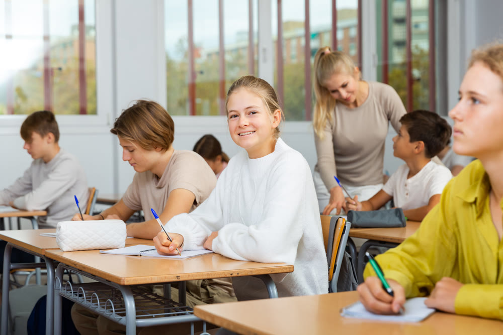 Group of school kids and teacher during lesson