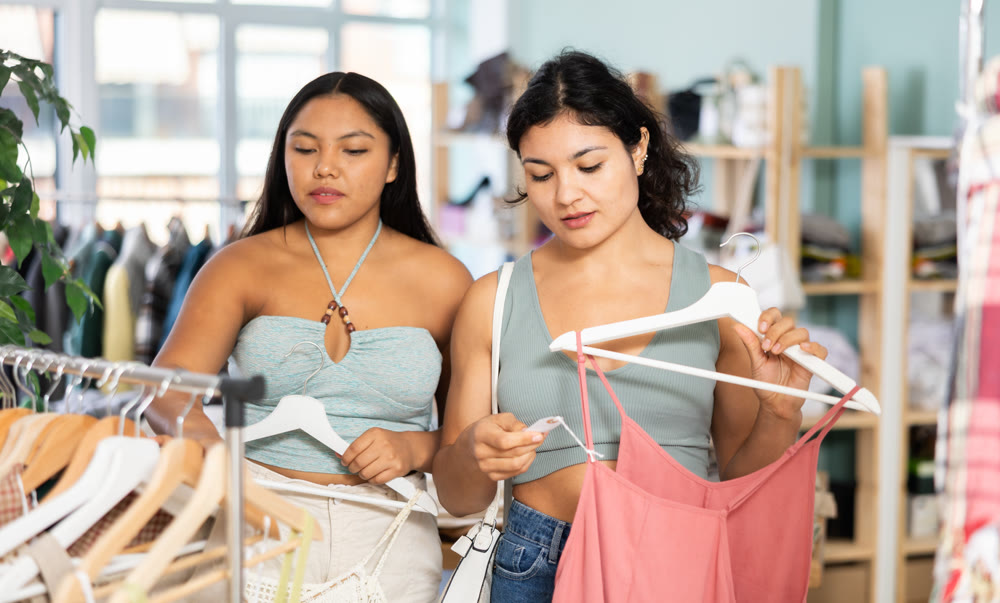 Two Latinas choose summer clothes together