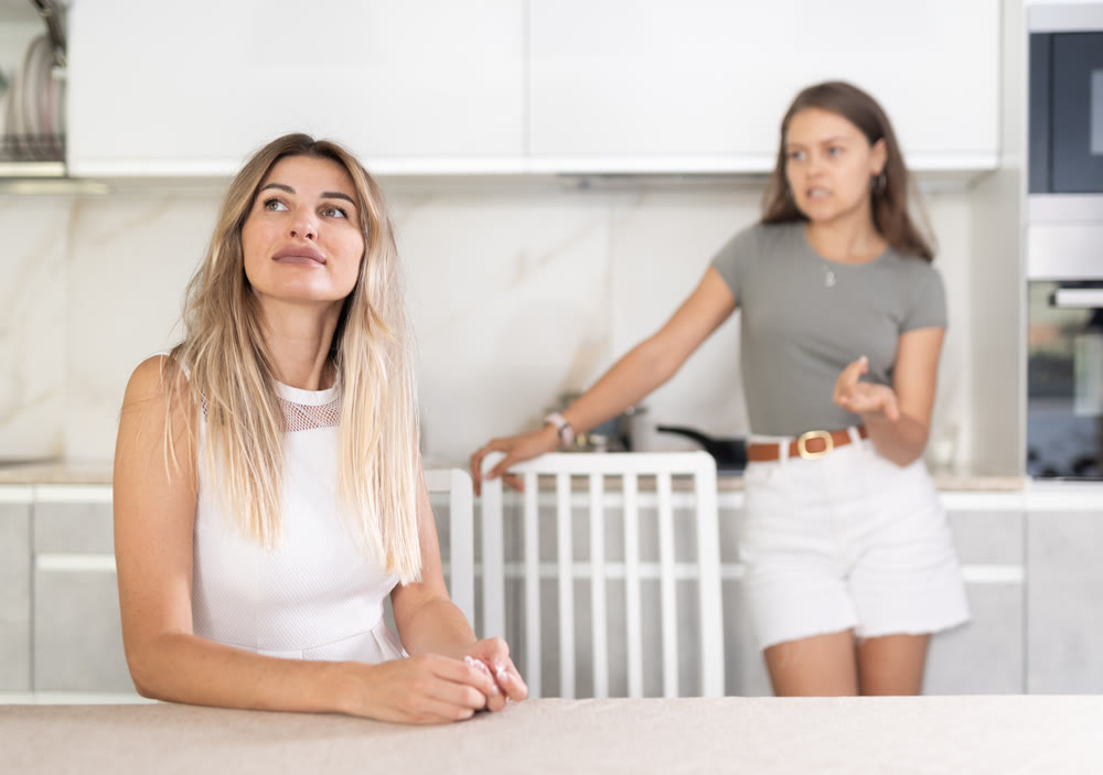 Adult girl shouting at stressed mother