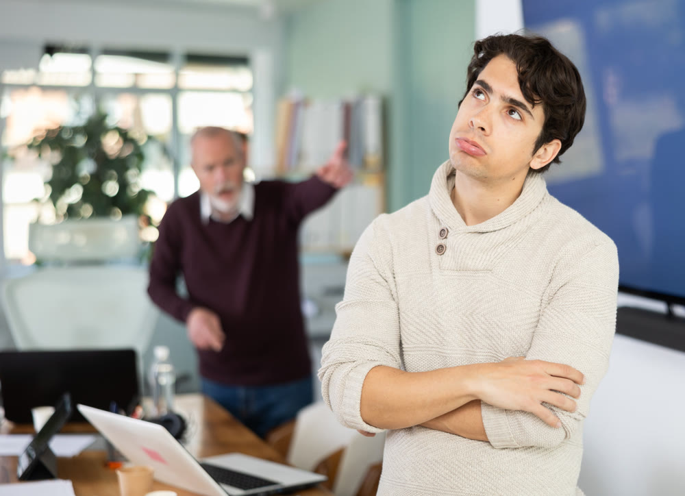 Adult man experiences abuse at work, is criticized by his mature male superiors.