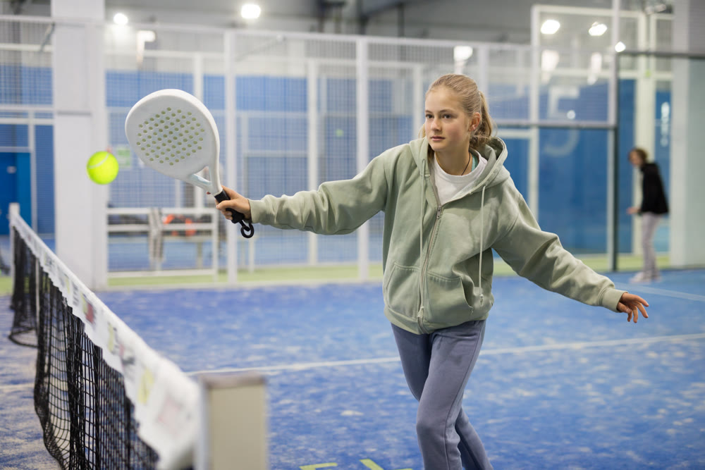 Girl tennis player playing padel tennis