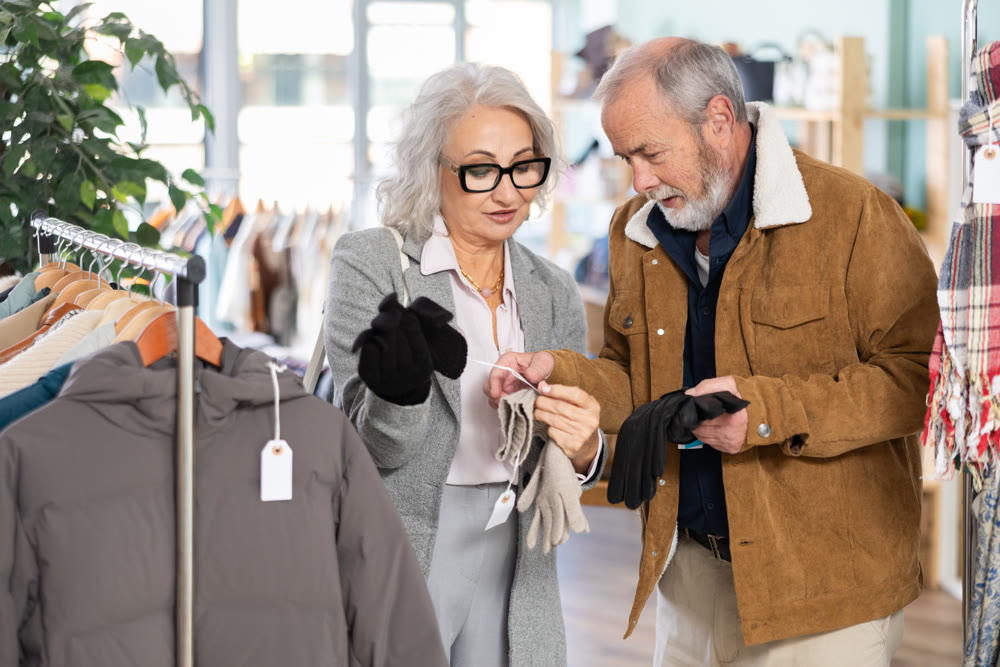 Mature couple spend time in shop and choose gloves