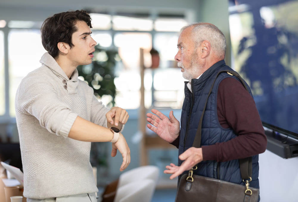 Upset senior man employee of company quits job, and guy manager shouts after him.