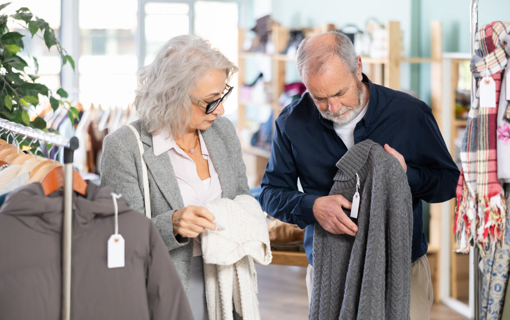 Mature man and woman buying a sweater in a store