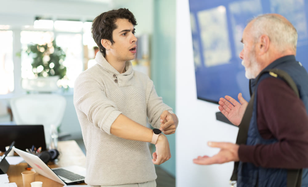 Upset senior man employee of company quits job, and guy manager shouts after him.