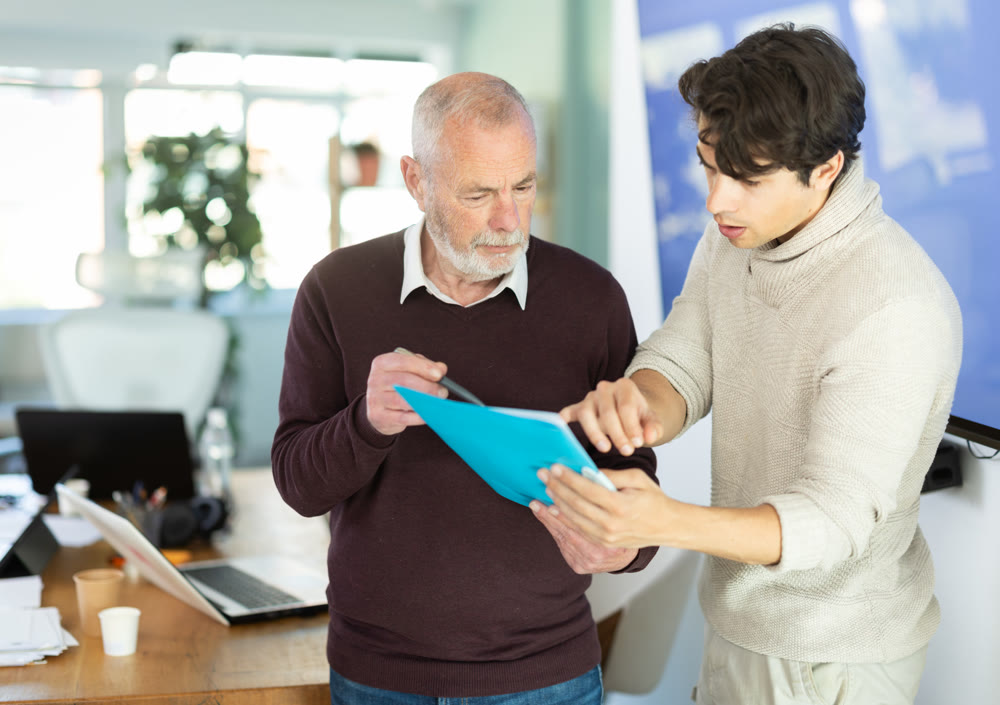 Men with papers in hands talk and discuss working issues