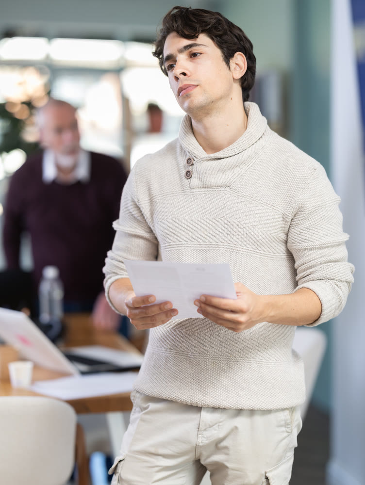 Sad guy subordinate with dismissal statement is criticized by his senior male superiors