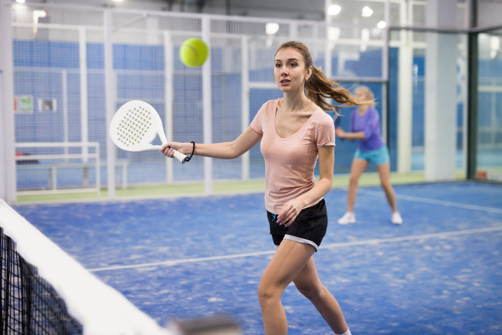 Portrait of a young woman playing padel