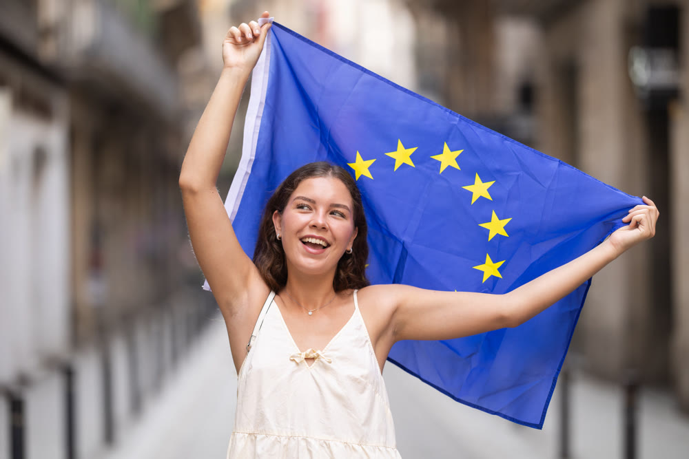 Young woman with EU flag on city street