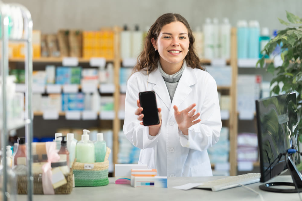 Female pharmacist offers to download app on smartphone