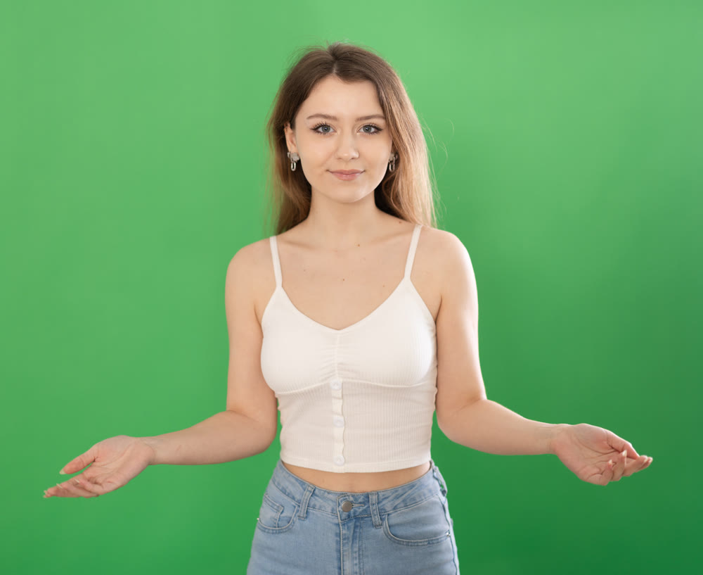 Chroma key compositing. Portrait of woman posing on green screen