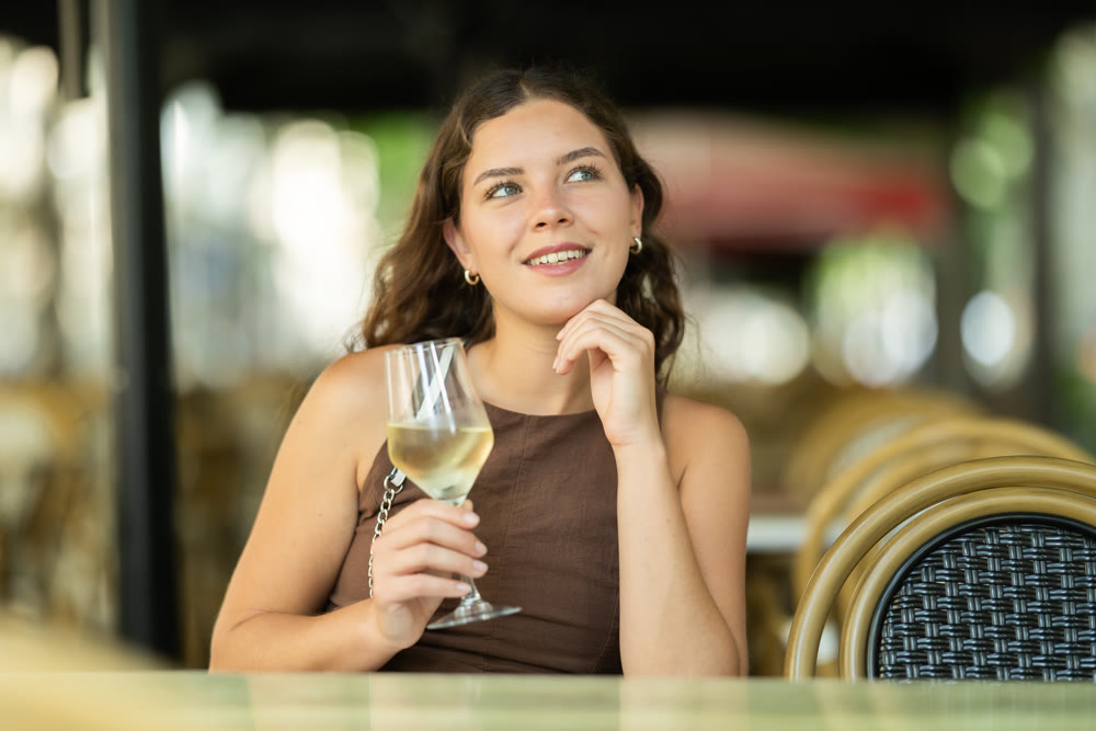 Woman sitting in a cafe with a glass of wine