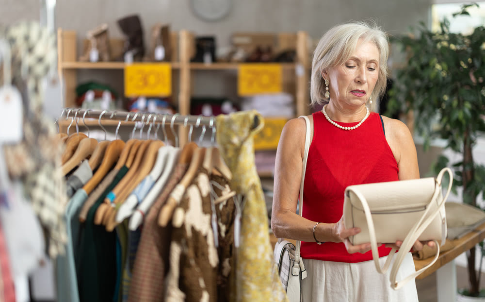 Elderly women choosing handbag in store