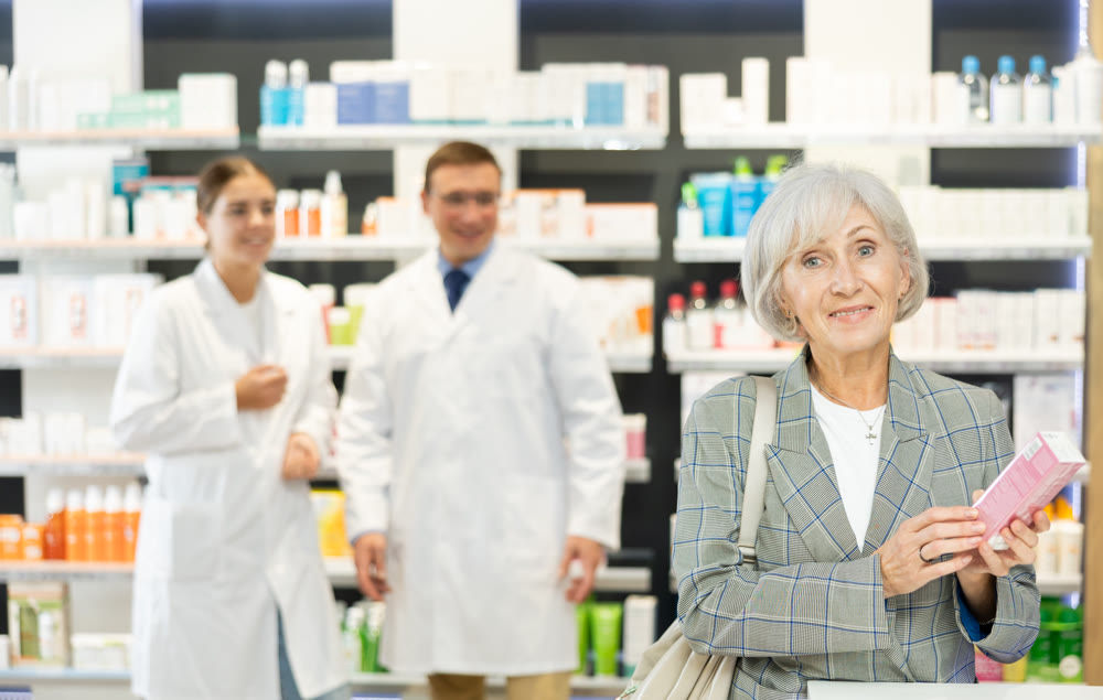 Old woman client choosing convenient care product in box