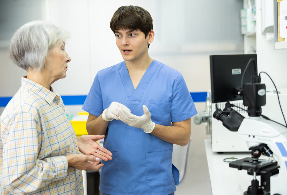 Young veterinarian talking to concerned mature woman at veterinary clinic