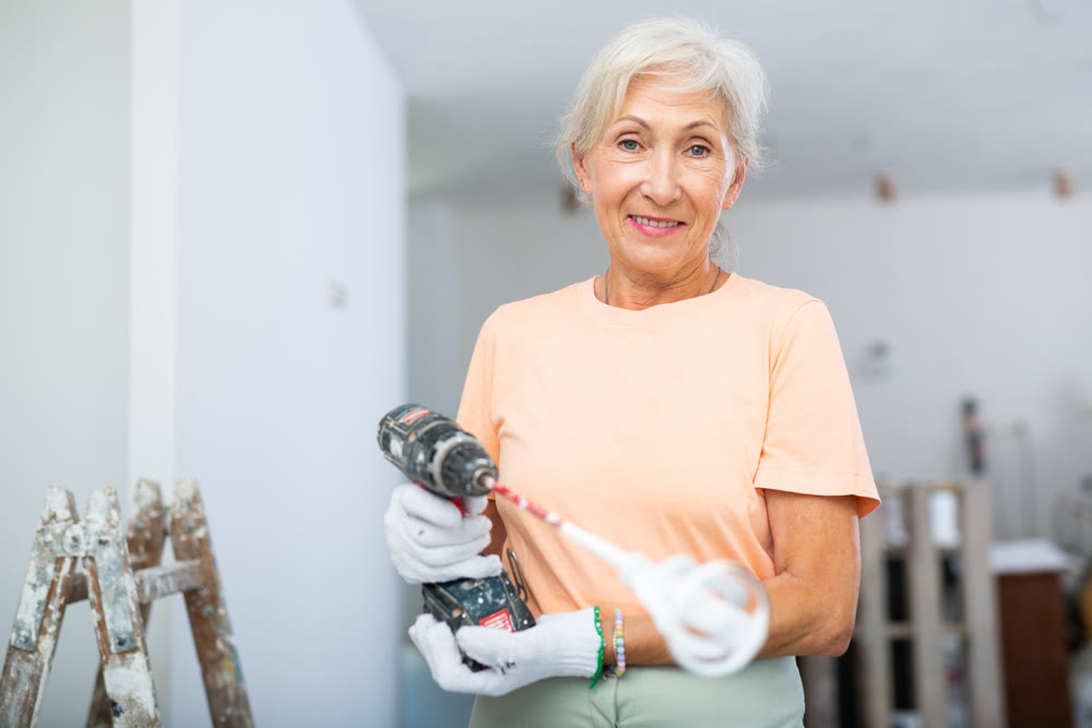 Mature woman posing with home renovation tools