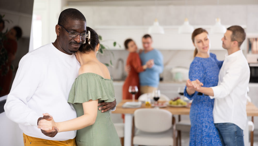 Couples of men and women dancing slow dance