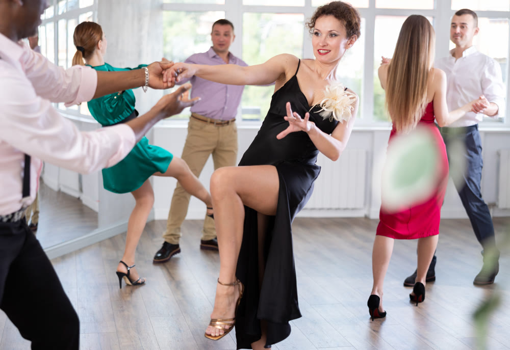 Man and woman practicing swing dance in dancing studio
