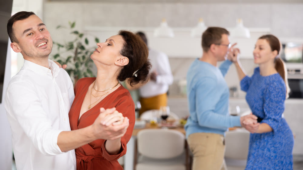 Couples of men and women dancing slow dance