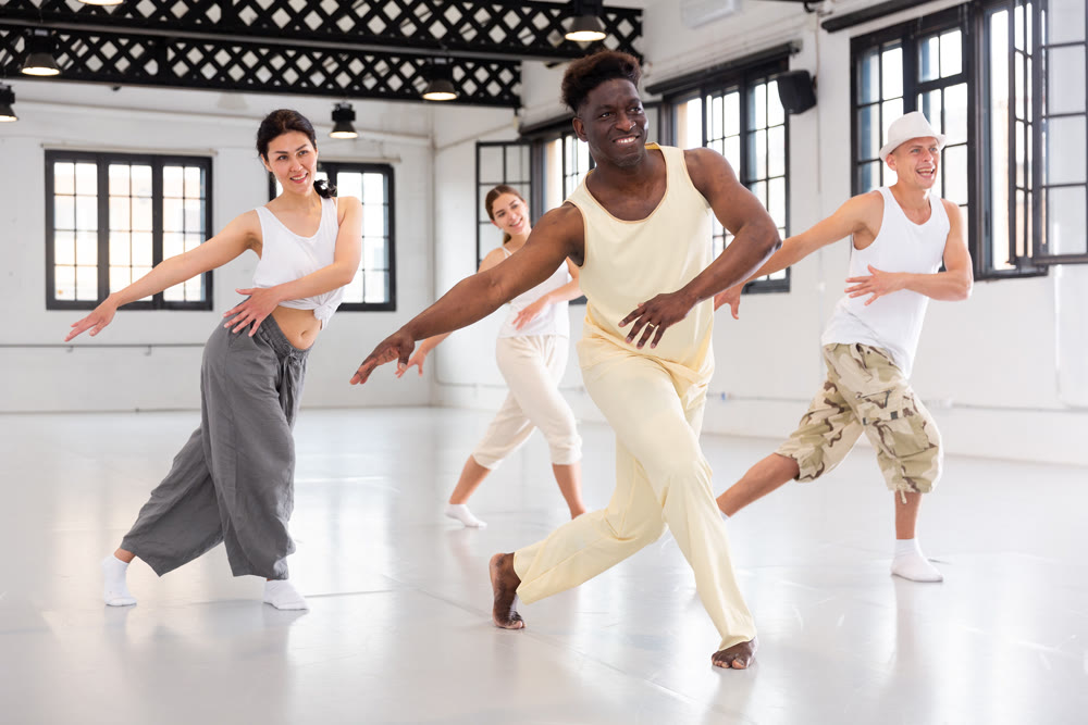 Group of young people learning modern dance movements