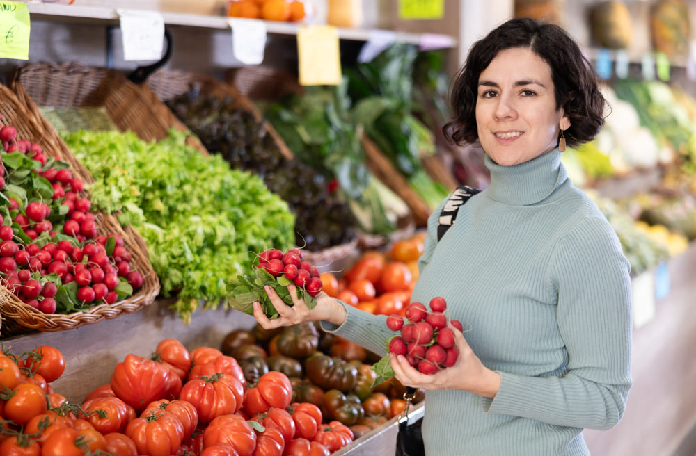 Woman choosing fresh radishes