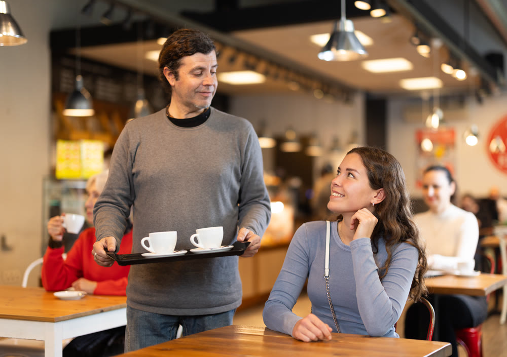 Man came to girlfriend with coffee on tray, meeting relatives in food court
