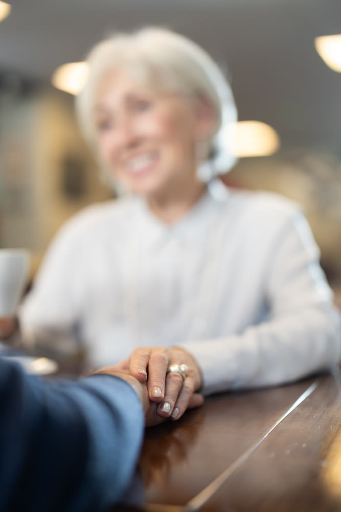 Senior spouses in cafe, chat and joke, flirting, eat and drink coffee