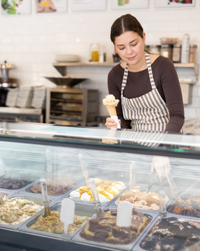 woman on a cafe seller offers ice cream