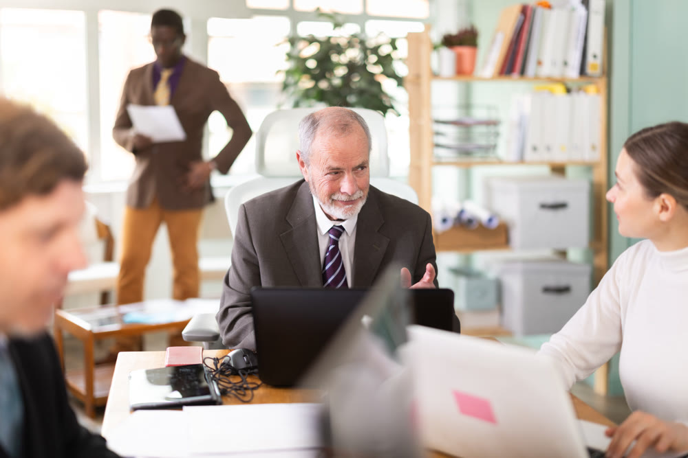 Mature man working in a team in an office