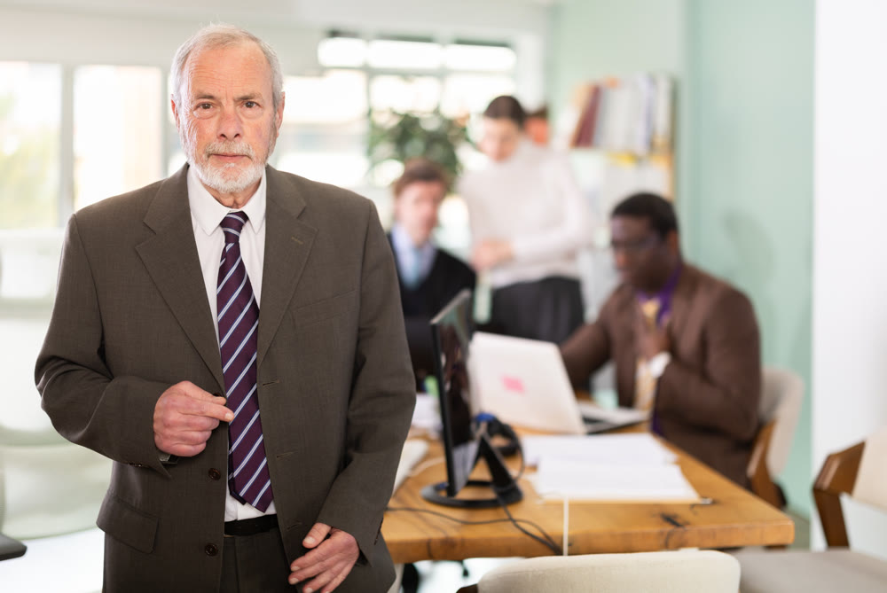 Portrait of senior businessman to office