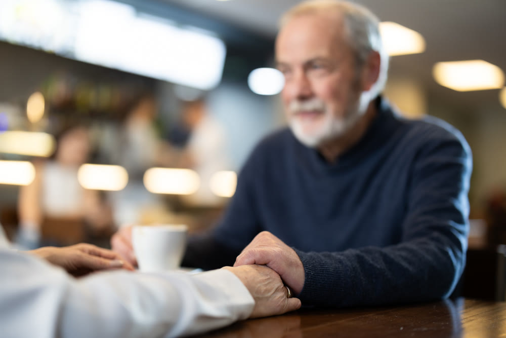 Senior spouses in cafe, chat and joke, flirting, eat and drink coffee