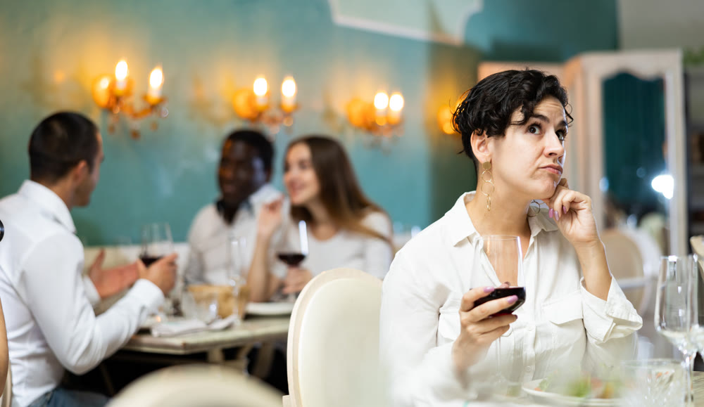 Sad woman with glass at the restaurant