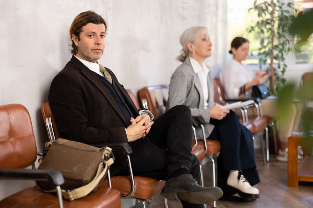 Adult man in suit sitting on chair in the office