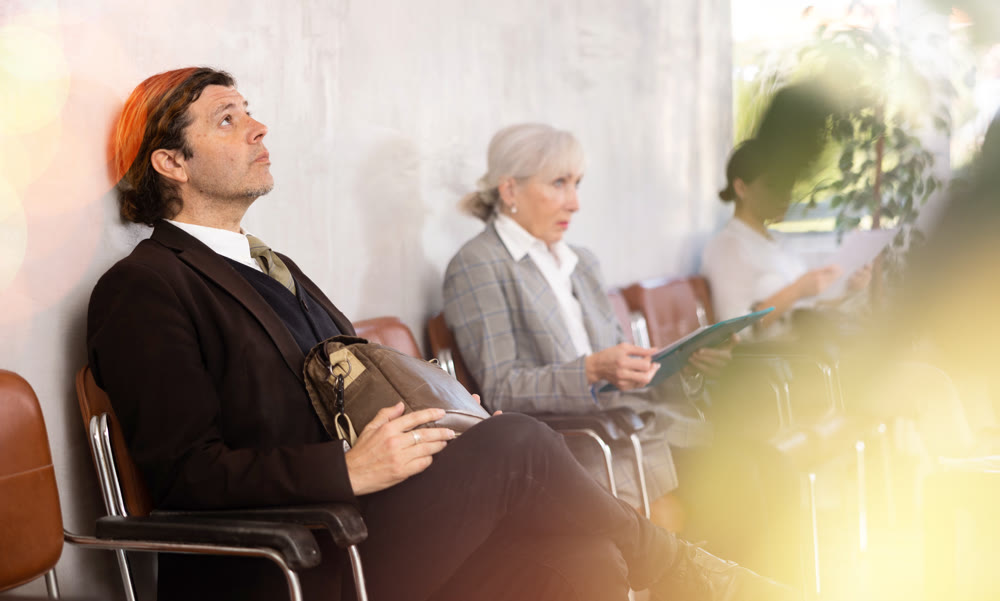 Portrait of serious man waiting for job interview while sitting at office lobby