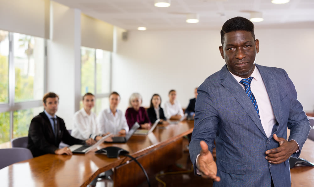 Confident middle-aged mature african businessman giving hand for handshake