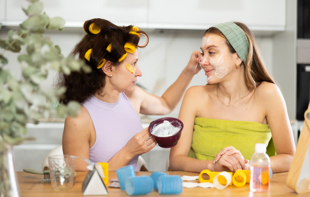 Applying mask to woman's face with brush