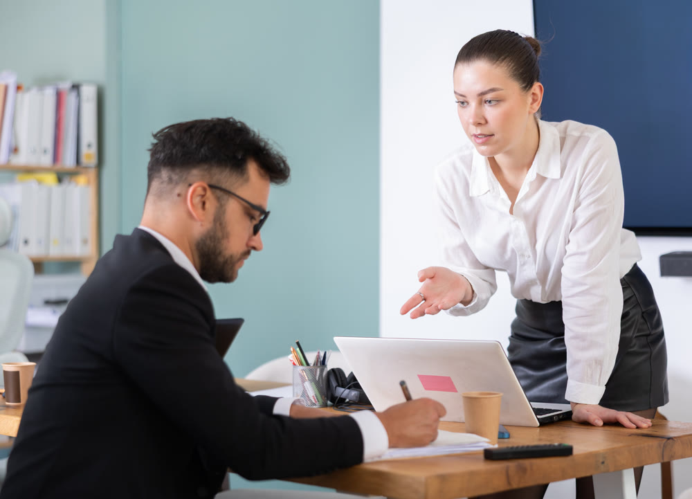 Colleagues business partners at office discuss financial data project documents paperwork