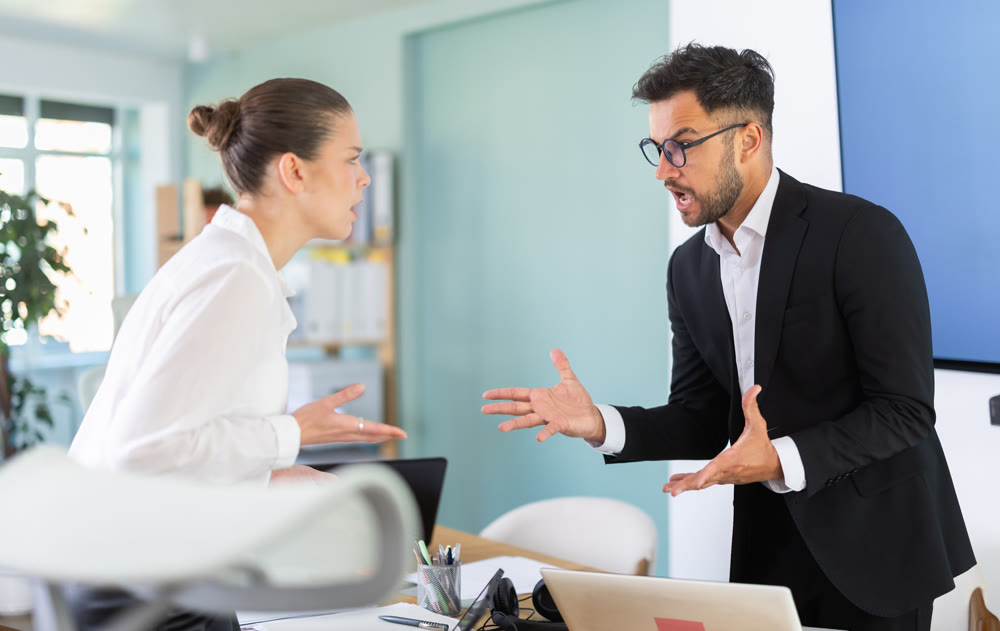 Quarrel between two managers in office - man and woman shout at each other, dissatisfied with their work
